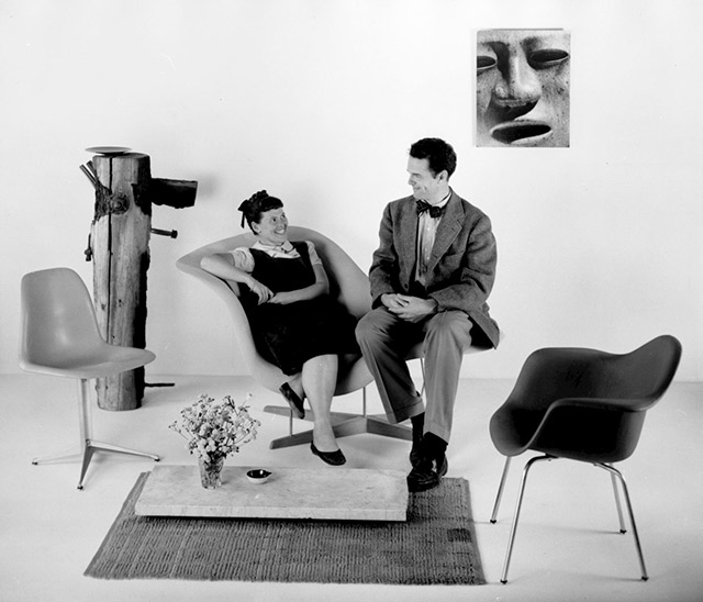 Charles and Ray Eames with their competition entries, seated on La Chaise